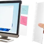 Two semi-transparent Clip Strip computer monitor memo boards attached to the sides of a desktop monitor, holding sticky notes