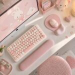 Pink oval mouse pad with an integrated gel wrist rest, designed for ergonomic support and smooth mouse movement.