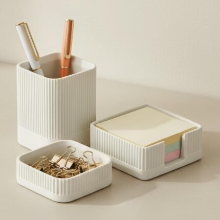 A set of three gray concrete desk organizers, including a tall pen holder, a square notes holder, and a small metal clip hold