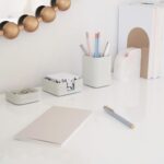 A set of three gray concrete desk organizers, including a tall pen holder, a square notes holder, and a small metal clip hold