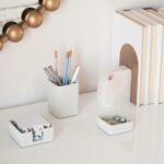 A set of three gray concrete desk organizers, including a tall pen holder, a square notes holder, and a small metal clip hold