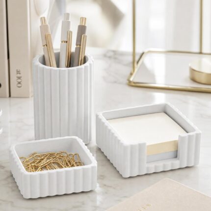 A set of three gray concrete desk organizers, including a pen holder, a notes holder, and a small dish for clips, arranged on